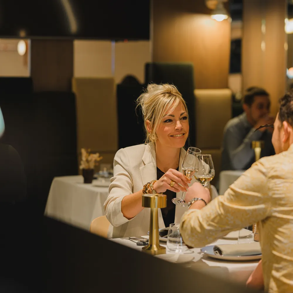 Guests share a moment over glasses of wine in the dining room